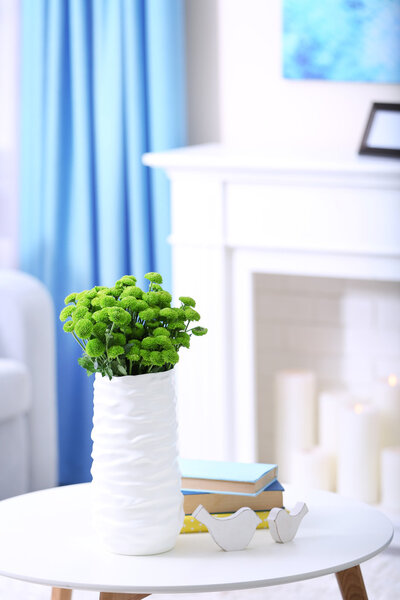 green chrysanthemums in vase on table