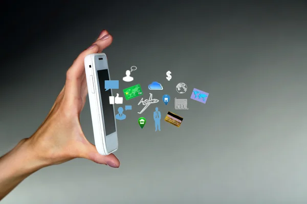 Smartphone a mano con icone aziendali — Foto Stock