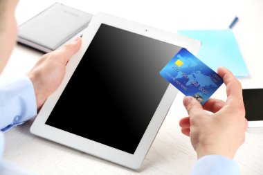 Kredi kartı ve tablet işyeri arka planda tutan adam
