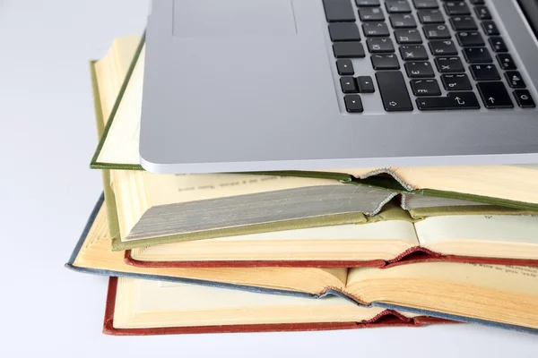 Stack of books with laptop — Stock Photo, Image