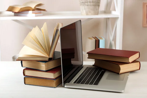 Stack of books with laptop — Stock Photo, Image