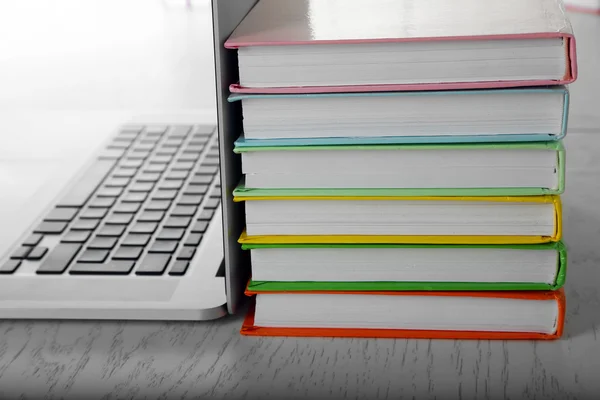 Stack of books with laptop — Stock Photo, Image