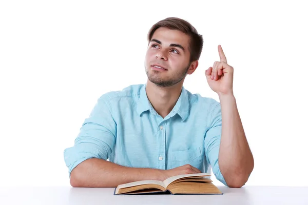 Young man reading book at table — Stock Photo, Image