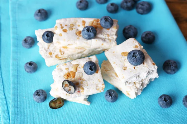 Sweet nougat with nuts and blueberries on napkin close up — Stock Photo, Image