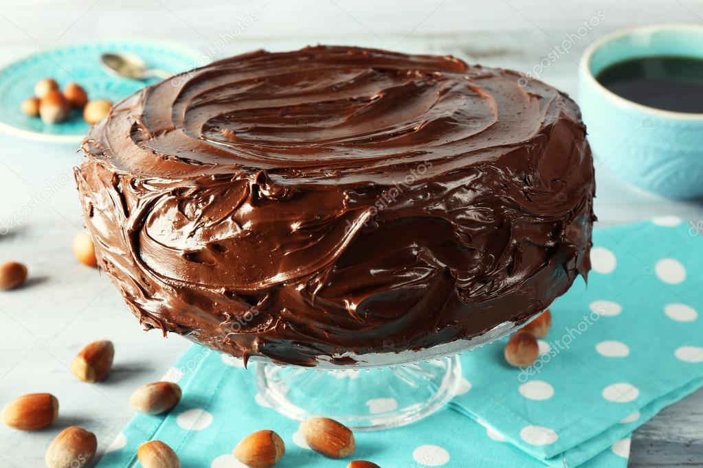 chocolate cake with hazelnuts and coffee on table