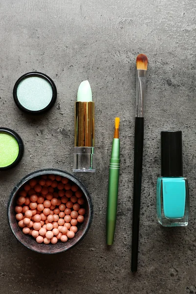 Different cosmetics on dark grey background — Stock Photo, Image