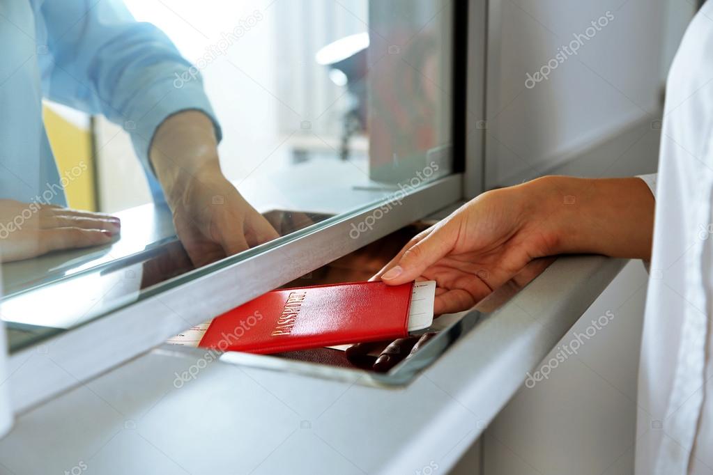 Woman buying tickets with passport at box office