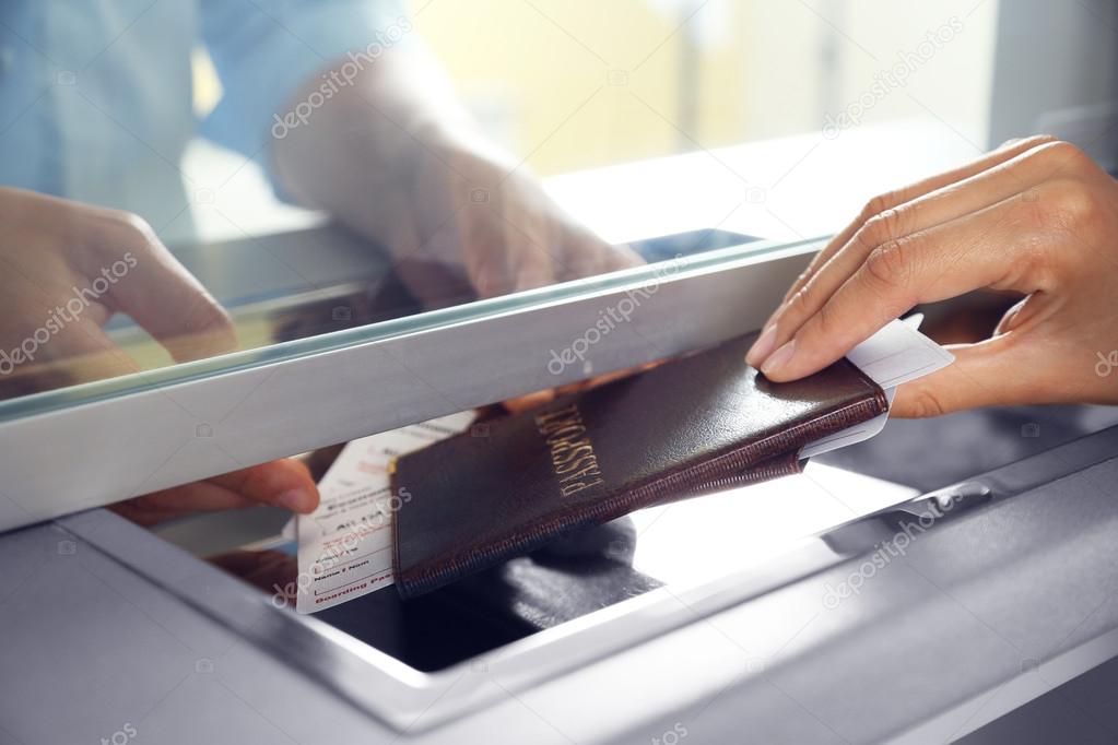 Woman buying tickets with passport at box office