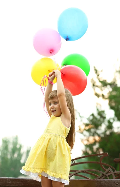 Little girl with balloons — Stock Photo, Image