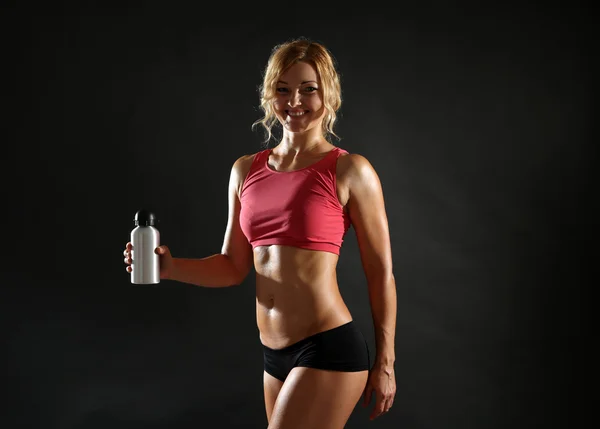 Athletic woman on dark background — Stock Photo, Image