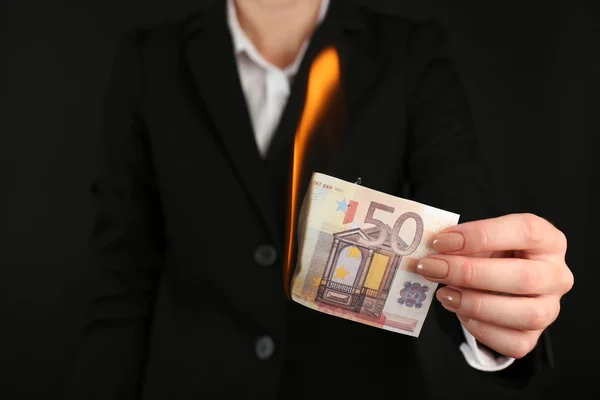 Woman burning Euro banknotes closeup Stock Picture