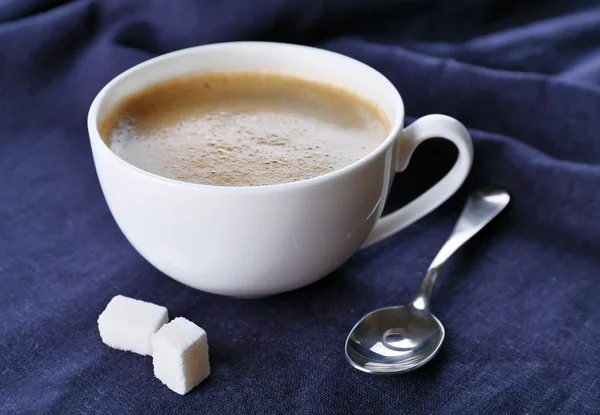 Cup of coffee and sugar on black tablecloth closeup — Stock Photo, Image