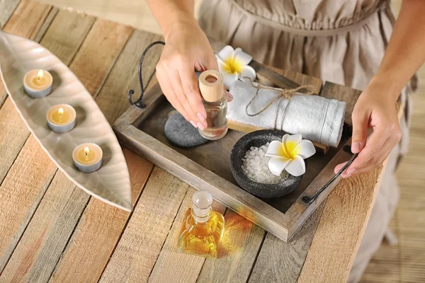 Kvinnliga händer med bricka med spa-produkter, på spasalong — Stockfoto