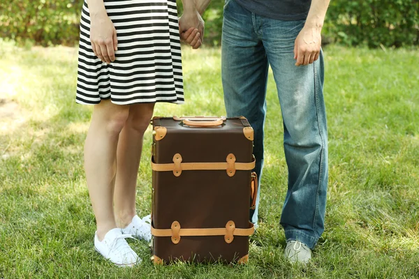 Young couple with vintage suitcase outdoors — Stock Photo, Image