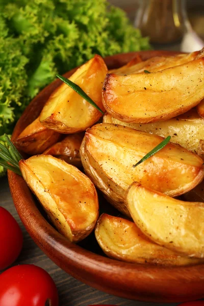 Baked potato wedges on table, closeup — Stock Photo, Image