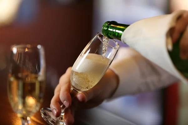 Bartender pouring champagne