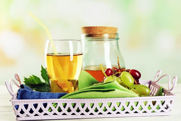 Glass and jug with juice on the server — Stock Photo, Image