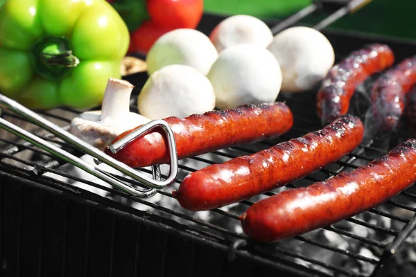 Sausages and vegetables on grill — Stock Photo, Image