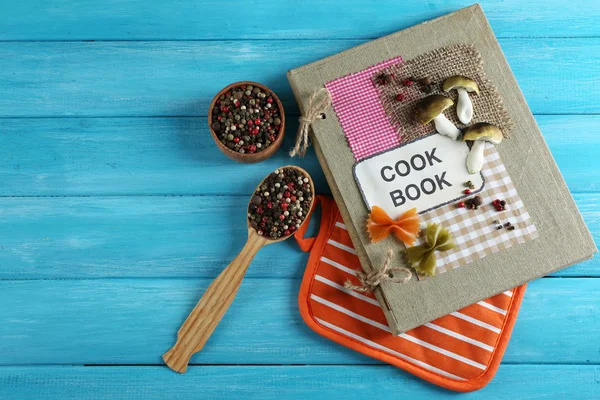 Decorated cookbook on blue wooden background — Stock Photo, Image