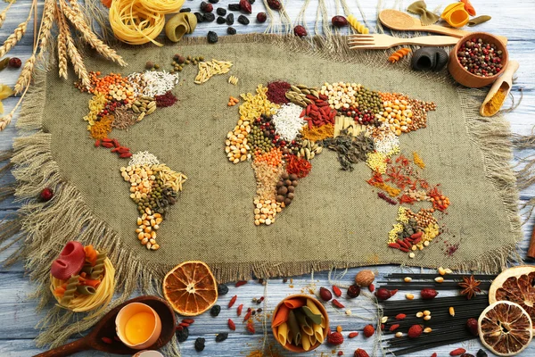 Spices on sackcloth on wooden background — Stock Photo, Image