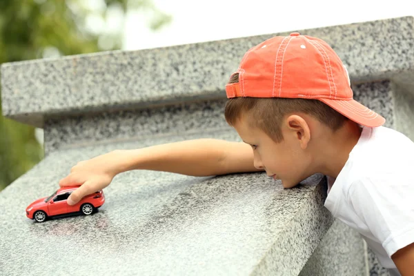 Little boy playing with toy car outside — Stock Photo, Image