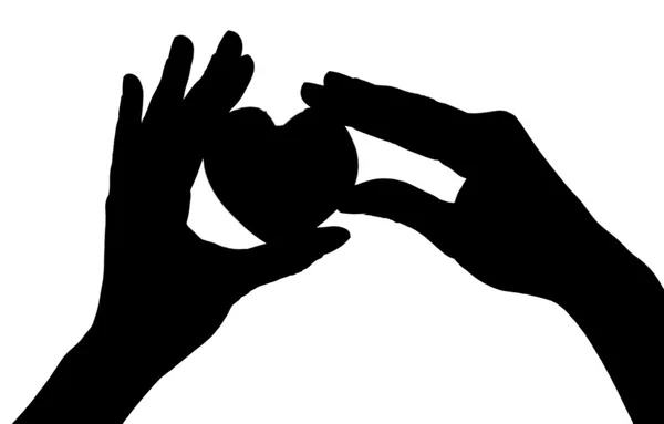 Silhouettes of hands with heart — Stock Photo, Image