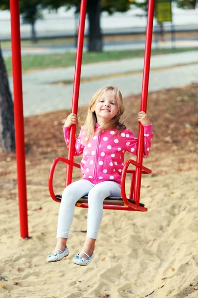 Little girl having fun on swing — Stock Photo, Image