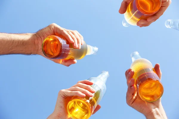 Bottles of beer in people's hands — Stock Photo, Image