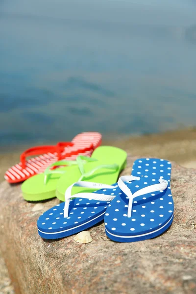 Bright flip-flops on stone — Stock Photo, Image