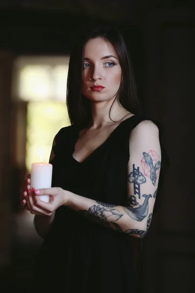 woman with candle sitting in chair