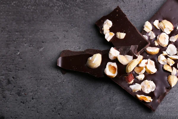 Black chocolate pieces and nuts — Stock Photo, Image