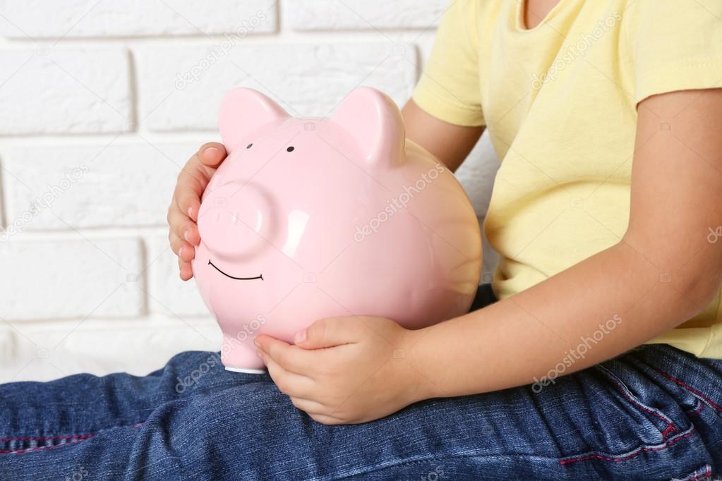 Little girl with the pig  moneybox