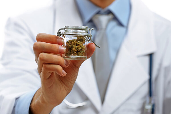 Doctor  holding bottle with medical cannabis