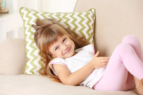 Girl  with smart phone lying on sofa — Stock Photo, Image