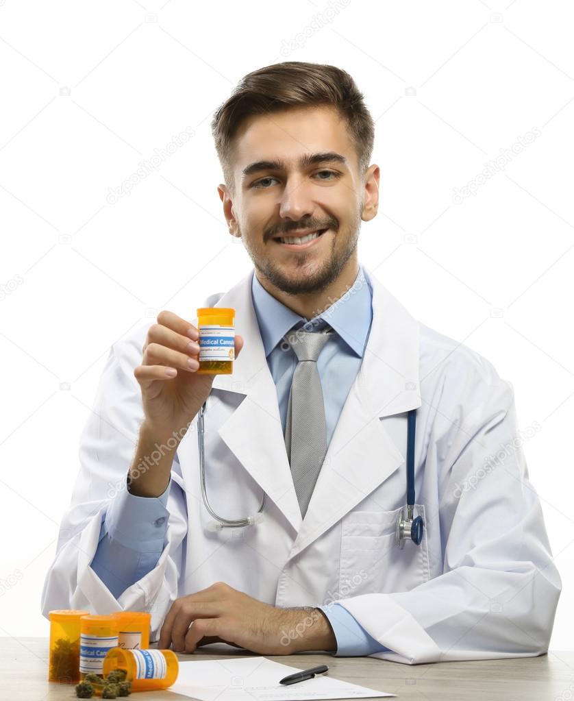 Doctor holding bottle with medical cannabis isolated on white