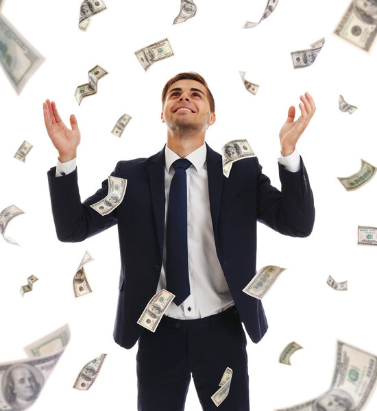 Businessman standing in the rain of money
