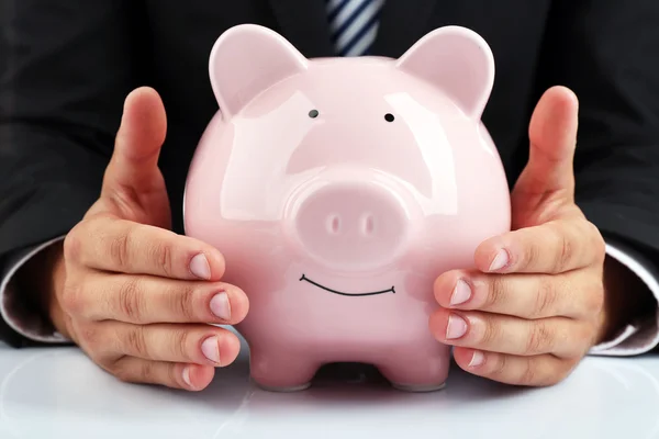 Man with piggy-bank on white background — Stock Photo, Image