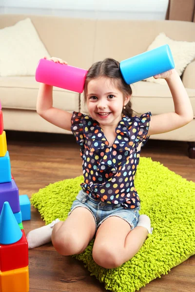 Menina brincando com cubos em casa interior fundo — Fotografia de Stock