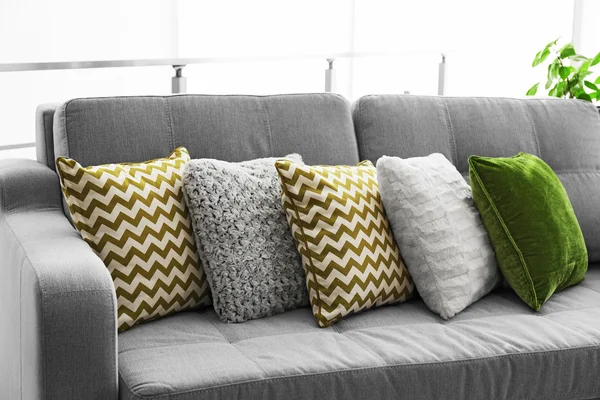 Sofa with colorful pillows in room — Stock Photo, Image