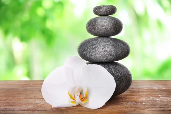 Stack of spa stones with orchid flower — Stock Photo, Image