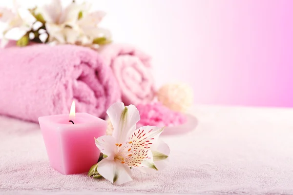 Spa treatment and flowers on wooden table, on light background — Stock Photo, Image