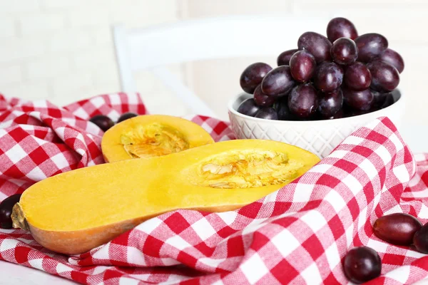 Pumpkin and grapes on table — Stock Photo, Image