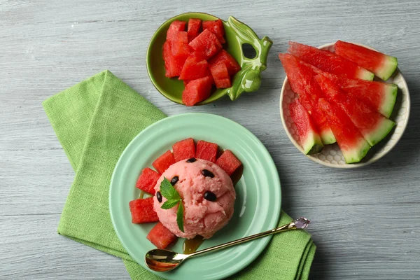 Watermelon ice cream on plate on color wooden background — Stock Photo, Image