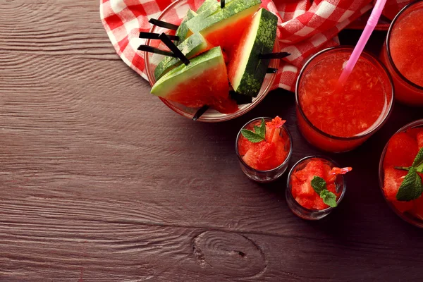 Cold watermelon pieces in glasses, on wooden table background — Stock Photo, Image