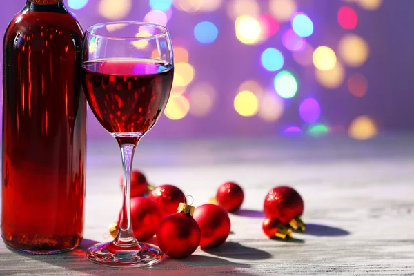 Wine and Christmas decoration on bright background — Stock Photo, Image