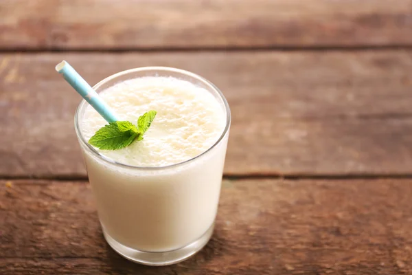 Fresh yogurt with mint on wooden background — Stock Photo, Image