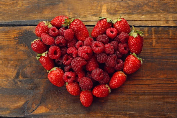 Heart shaped strawberries and raspberries — Stock Photo, Image