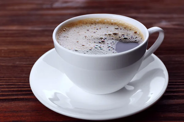 Cup of coffee on wooden background — Stock Photo, Image