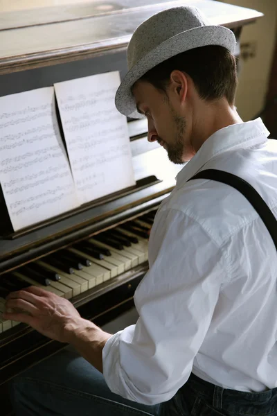 Hombre en sombrero haciendo música de piano — Foto de Stock