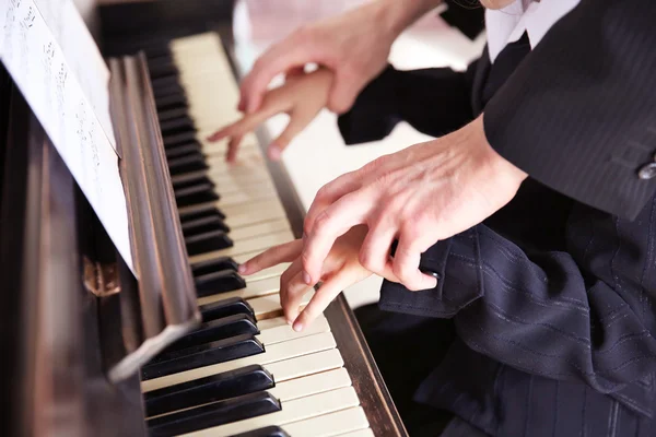 Man and girl hands piano playing Stock Image